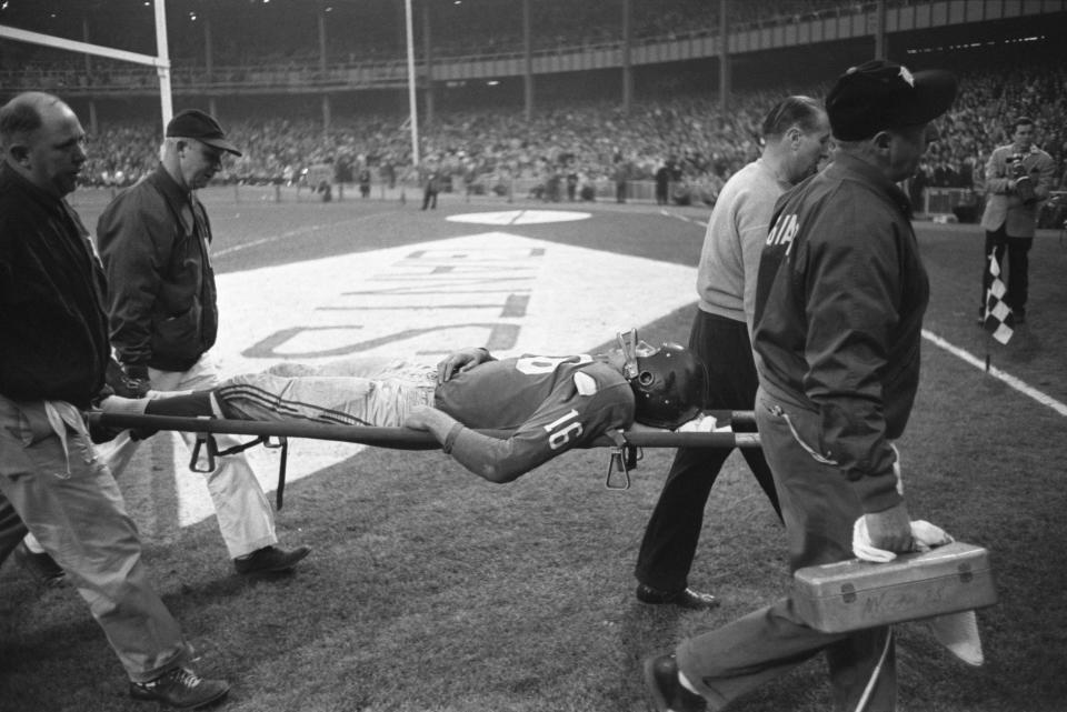 Gifford is carried off the field on a stretcher. (Bettmann Archive/Getty Images)