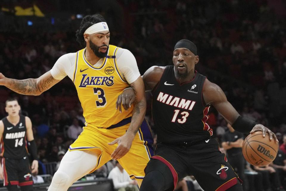 Lakers forward Anthony Davis, left, defends against Miami Heat center Bam Adebayo during the second half Wednesday.