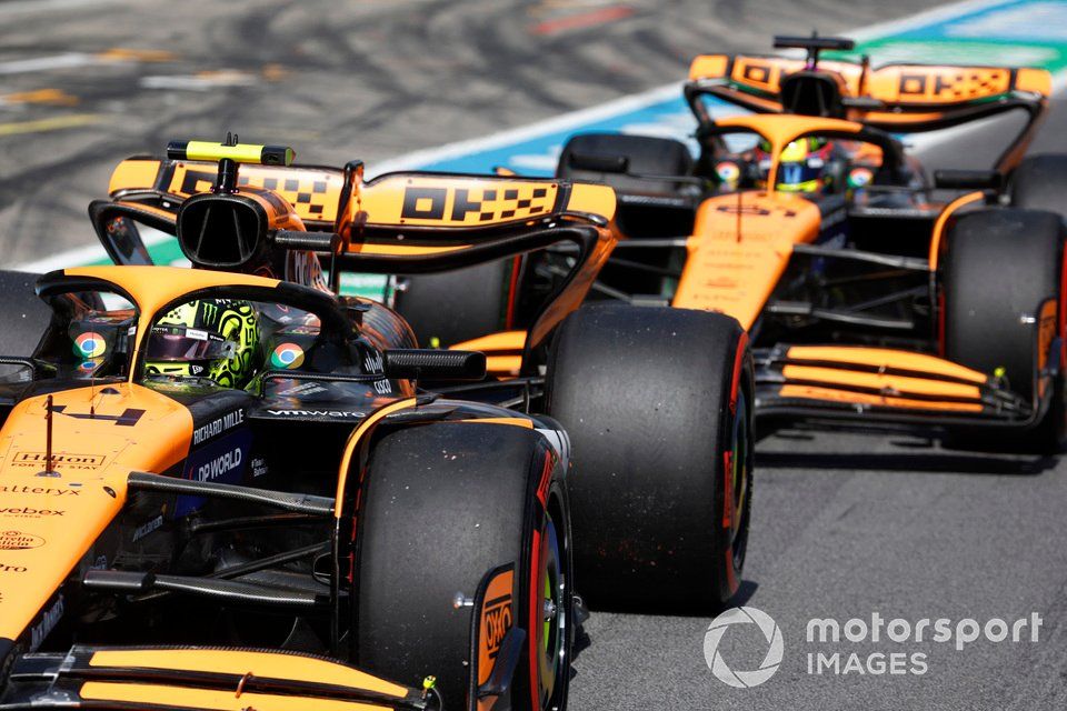 Lando Norris, McLaren MCL38, Oscar Piastri, McLaren MCL38, in the pit lane