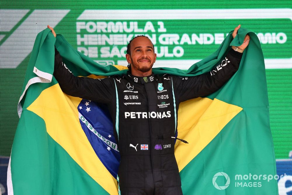 Lewis Hamilton, Mercedes, 1st position, on the podium with a Brazilian flag