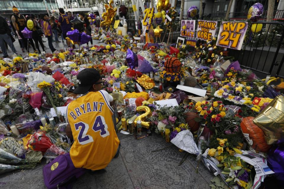 Xavier Davenport pays his respects to Kobe Bryant at a makeshift memorial for the Lakers star at L.A. Live.