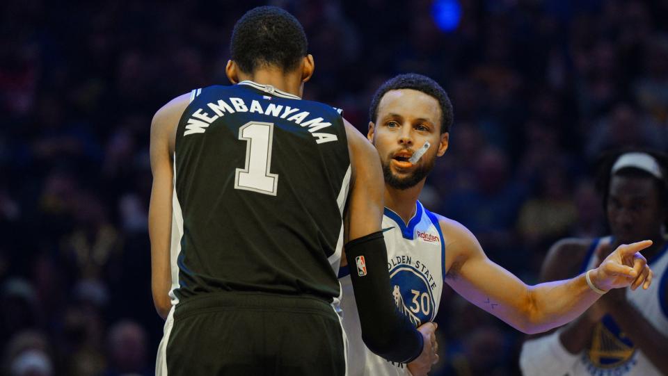 San Antonio Spurs' French forward-center #01 Victor Wembanyama greets Golden State Warriors' US guard #30 Stephen Curry before tip off of the NBA preseason game between the San Antonio Spurs and Golden State Warriors at Chase Center in San Francisco, California on October 20, 2023. (Photo by Loren Elliott / AFP) (Photo by LOREN ELLIOTT/AFP via Getty Images)