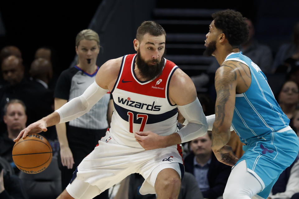 Washington Wizards center Jonas Valanciunas (17) drives into Charlotte Hornets forward Miles Bridges during the first half of an NBA basketball game in Charlotte, N.C., Monday, Feb. 3, 2025. (AP Photo/Nell Redmond)