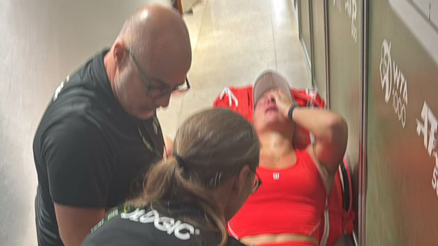 Tennis star collapses to ground and surrounded by paramedics after playing two matches in one day with nasty illness