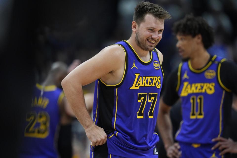 Lakers guard Luka Doncic laughs smiles during Saturday's game against the Denver Nuggets.