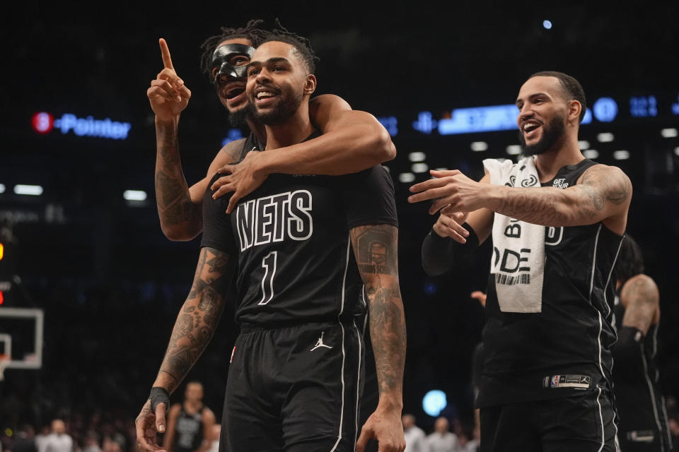 Brooklyn Nets' D'Angelo Russell (1) celebrates with teamamtes after making a three-point shot during the second half of an NBA basketball game against the Houston Rockets Tuesday, Feb. 4, 2025, in New York. (AP Photo/Frank Franklin II)