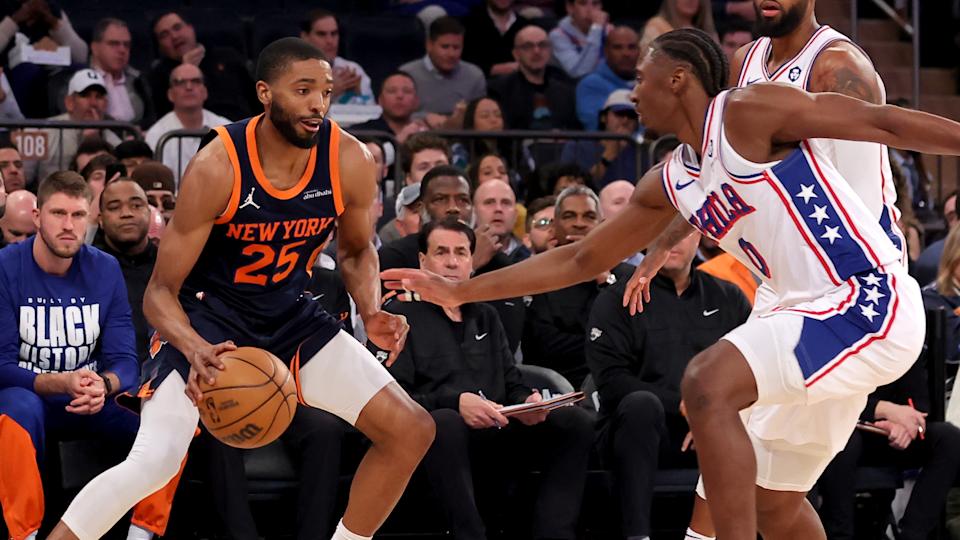 New York Knicks forward Mikal Bridges (25) controls the ball against Philadelphia 76ers guard Tyrese Maxey (0) and forward Paul George (8) during the first quarter at Madison Square Garden