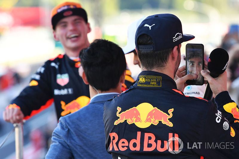 Daniel Ricciardo, Red Bull Racing celebrates with Lewis Hamilton's phone on the podium