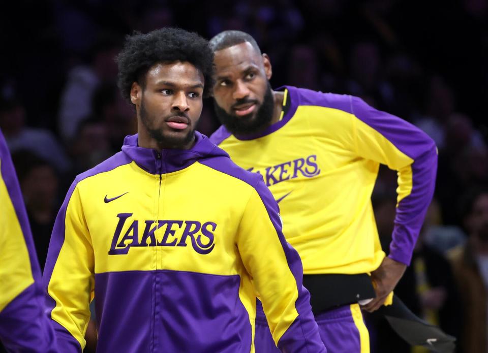 Bronny James, left, and his father, LeBron James, warm up before a game against the Atlanta Hawks.