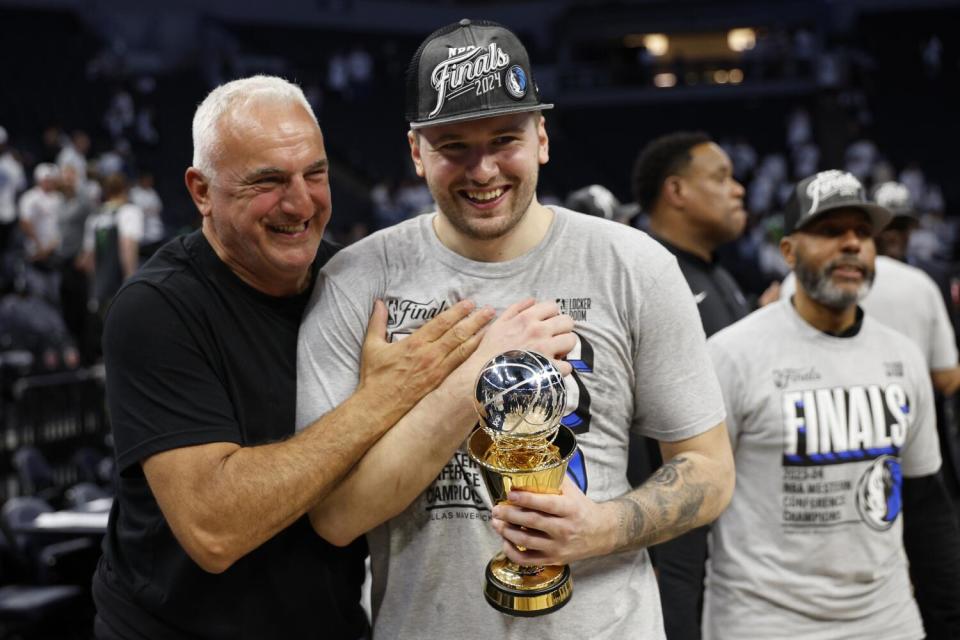 Dallas guard Luka Doncic, right, is congratulated by his father, Sasa, after defeating Minnesota to advance to NBA Finals.