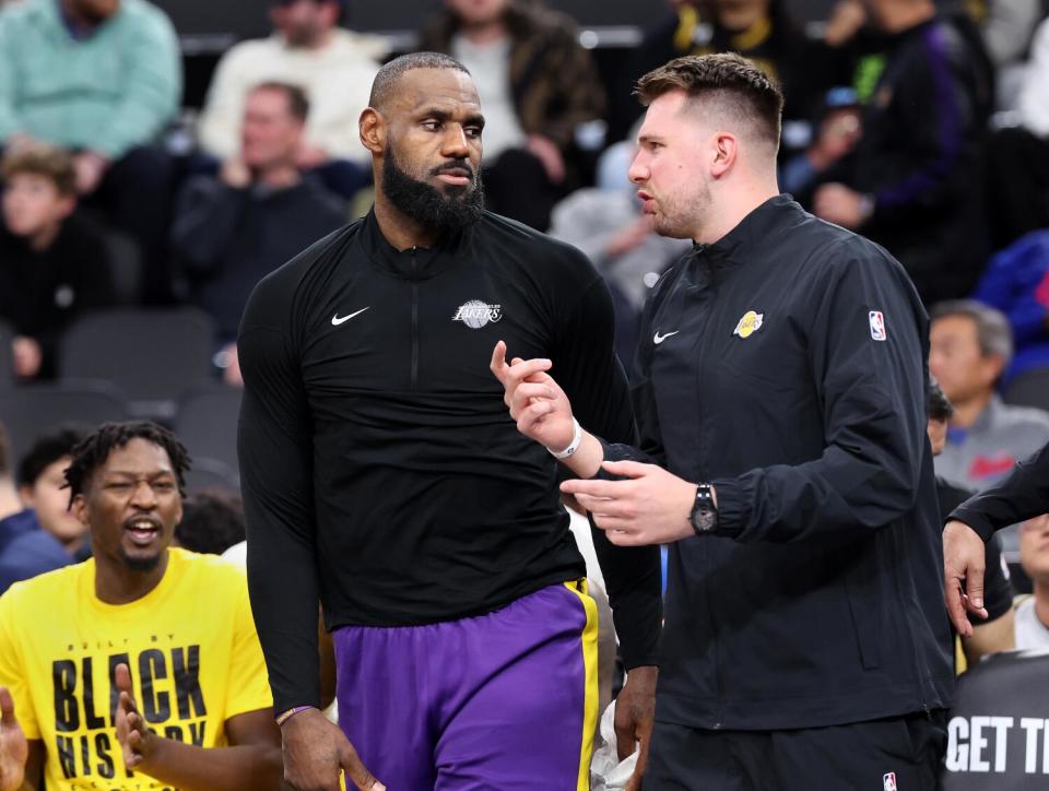 LeBron James, left, speaks with Luka Doncic talk during a game against the Clippers at the Intuit Dome on Tuesday.