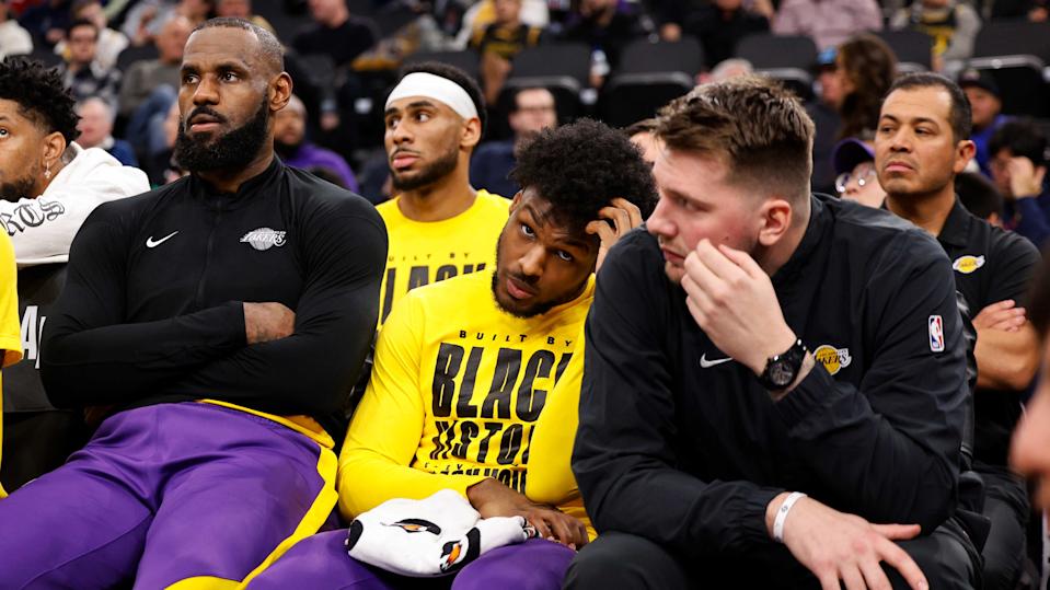 From left, Los Angeles Lakers forward LeBron James, guards Bronny James and Luka Doncic watch from the bench during an NBA basketball game against the Los Angeles Clippers, Tuesday, Feb. 4, 2025, in Inglewood, Calif. (AP Photo/Kevork Djansezian)