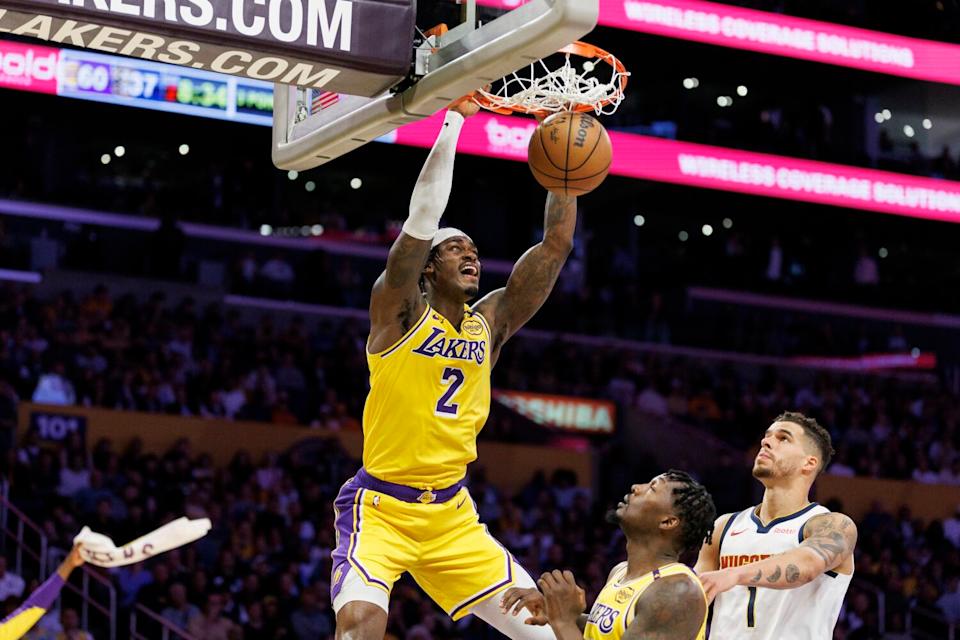 Lakers forward Jarred Vanderbilt dunks the ball in front of Denver Nuggets forward Michael Porter Jr.