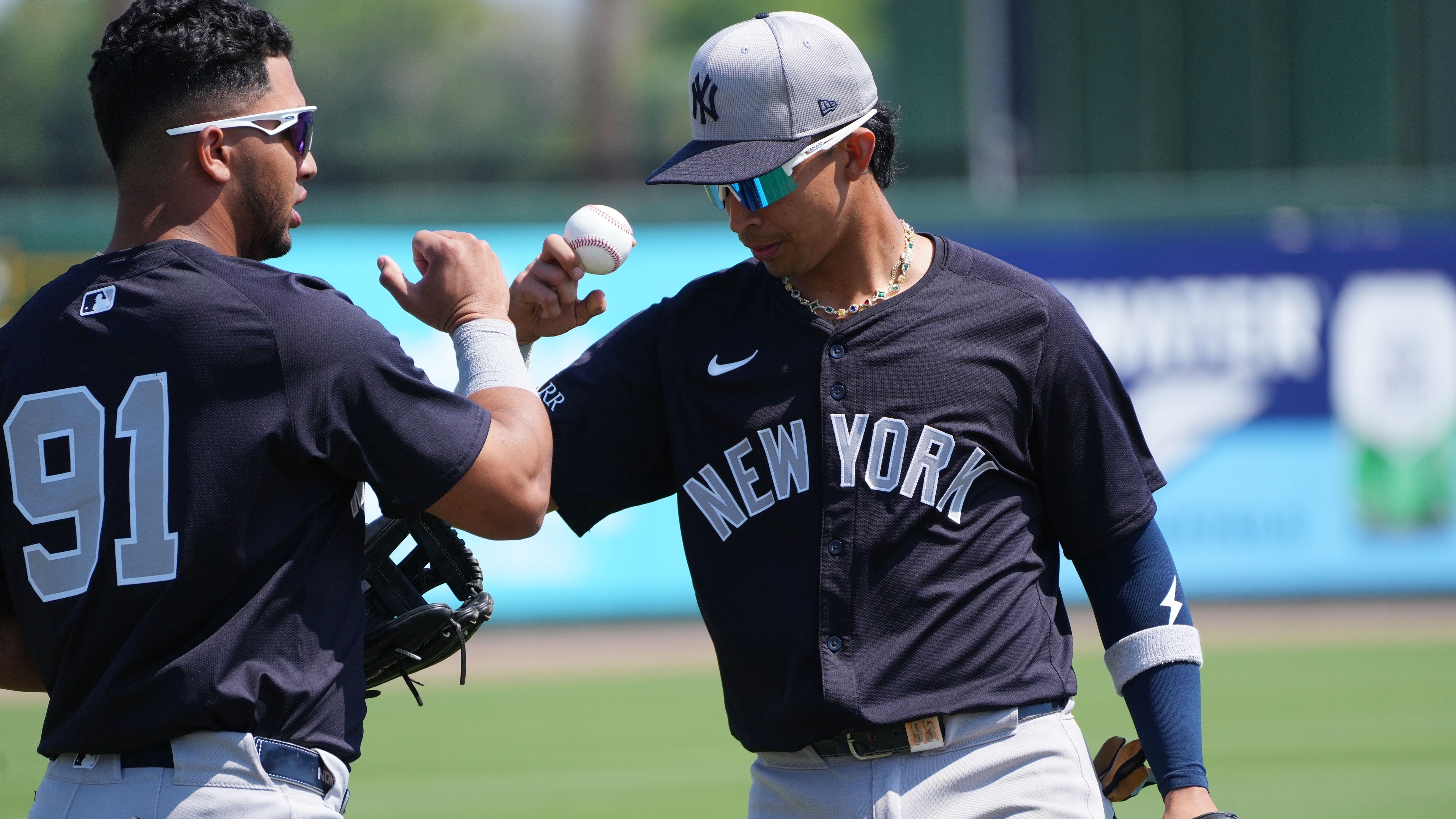 Mar 9, 2025; Jupiter, Florida, USA; New York Yankees third baseman Oswald Peraza (91) and New York Yankees first baseman Oswaldo Cabrera (95) greet each other during warm-ups before the game against the St. Louis Cardinals at Roger Dean Chevrolet Stadium.