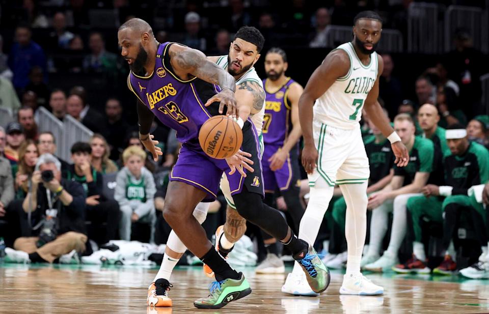 Celtics forward Jayson Tatum knocks the ball loose from Lakers forward LeBron James during a game Saturday in Boston.