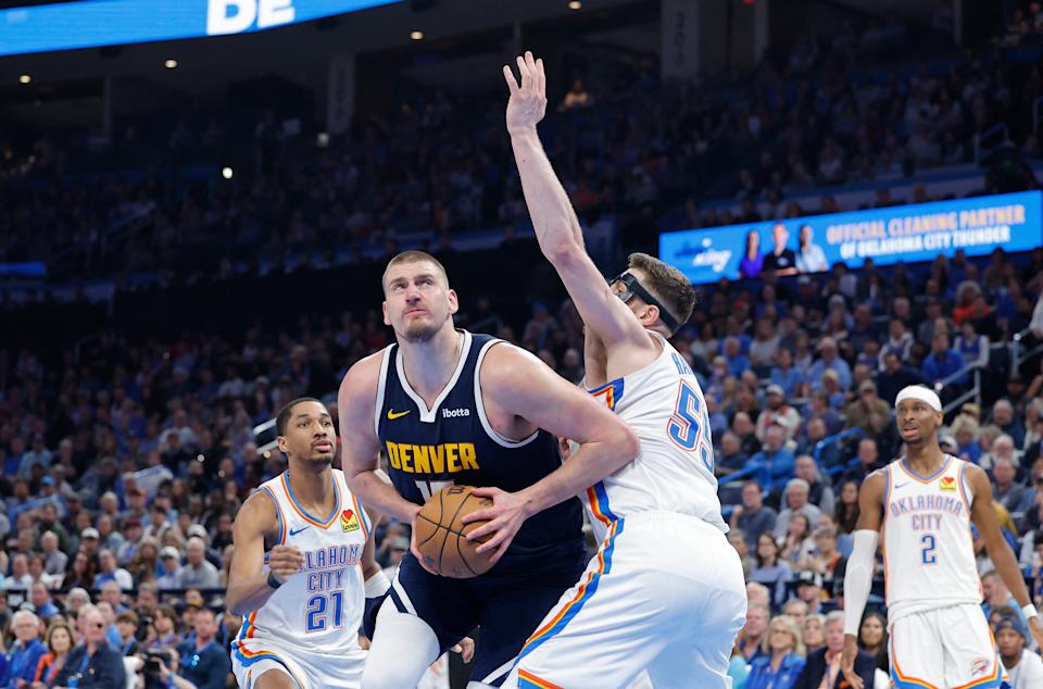 Mar 10, 2025; Oklahoma City, Oklahoma, USA; Denver Nuggets center Nikola Jokic (15) drives around Oklahoma City Thunder center Isaiah Hartenstein (55) during the second quarter at Paycom Center. Mandatory Credit: Alonzo Adams-Imagn Images