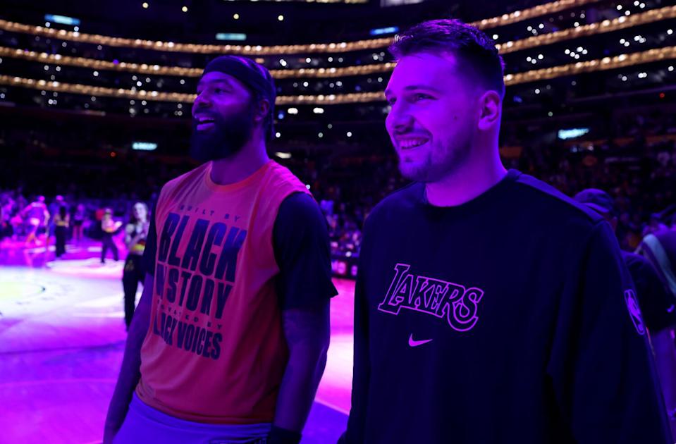 New Lakers Markieff Morris, left, and Luka Doncic, right, stand on the sideline for player introductions.