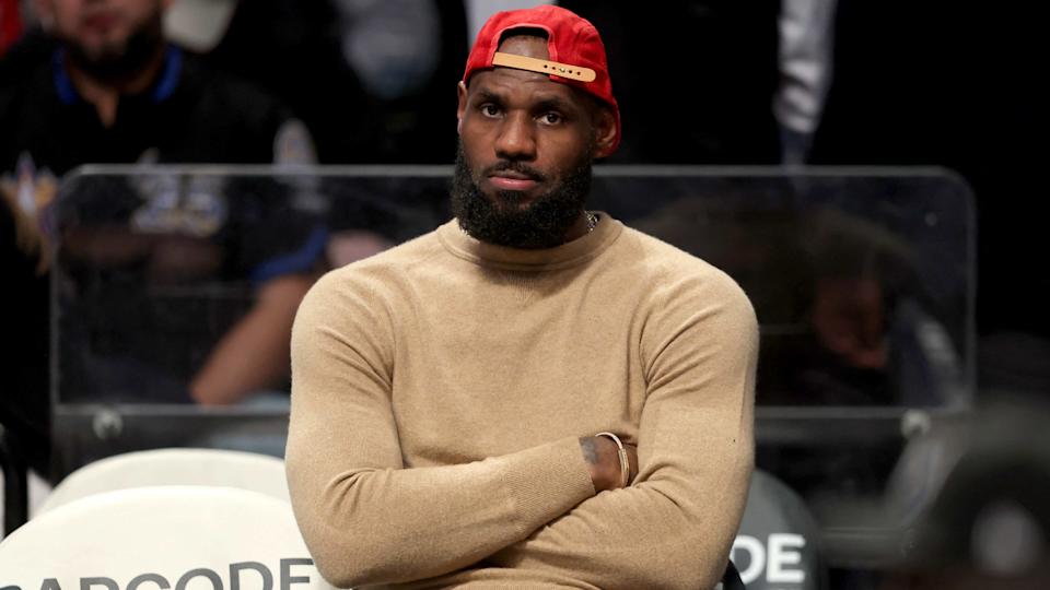 Mar 10, 2025; Brooklyn, New York, USA; Los Angeles Lakers forward LeBron James (23) watches from the bench during the fourth quarter against the Brooklyn Nets at Barclays Center. Mandatory Credit: Brad Penner-Imagn Images