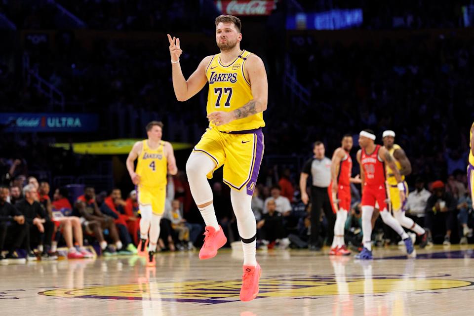 Luka Doncic skips down the court after making a three-point shot against New Orleans in the first half.