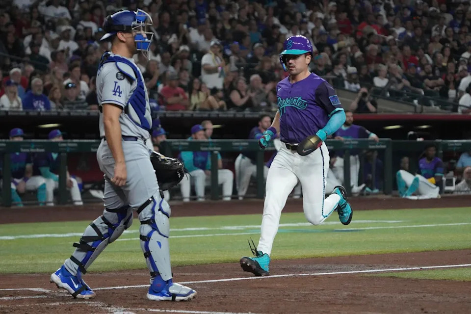 Arizona Diamondbacks outfielder Corbin Carroll scores against the Dodgers during the first inning Saturday in Phoenix.