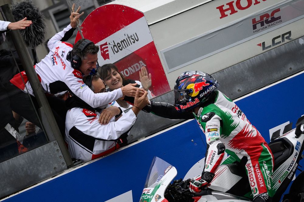 Zarco celebrates with team boss Lucio Cecchinello as he crosses the line for a memorable home win