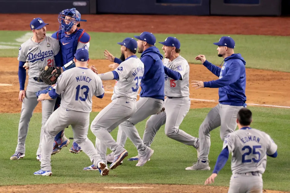 Dodgers celebrate with pitcher Walker Buehler, who jumps in the air after securing the final out of the World Series.