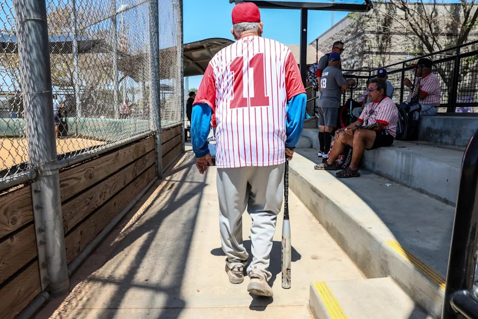 Agustin Quezada uses his bat as a cane.