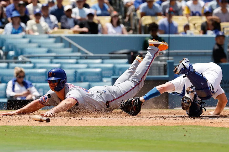 Pete Alonso slides past Dodgers catcher Will Smith to score a run for the Mets in the third inning Thursday.