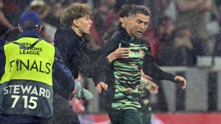 Major security breach as Cristiano Ronaldo is grabbed by pitch invader before guards are forced to intervene