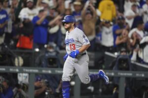 Max Muncy gets help from the rain, then hits a grand slam to lead Dodgers past hapless Rockies
