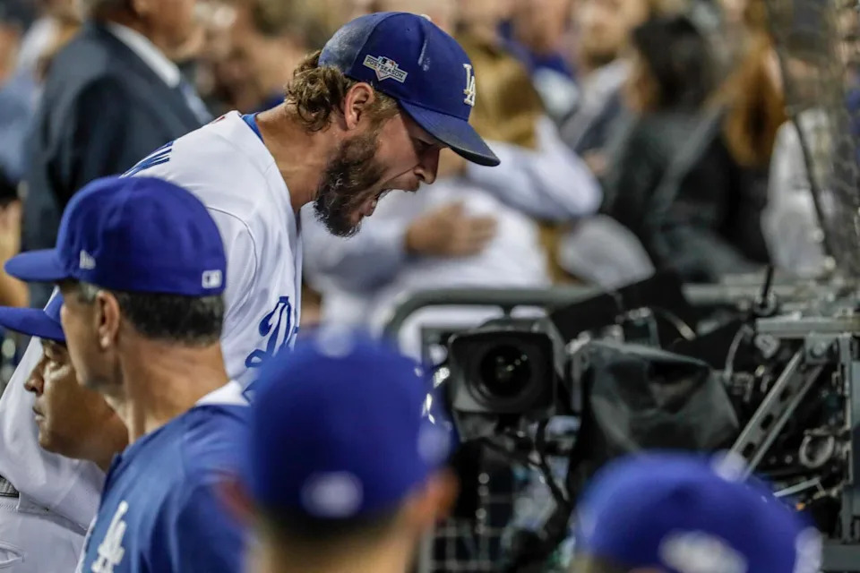 Clayton Kershaw (22) celebrates after striking out Nationals' Adam Eaton in relief to end the seventh inning.