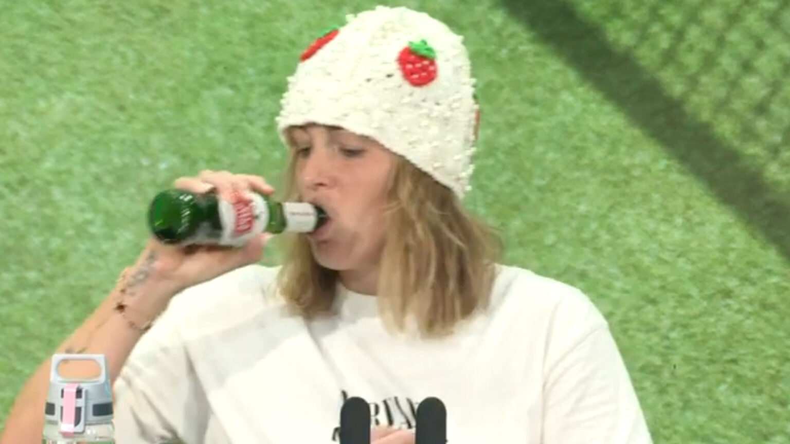 Wimbledon star necks beer while wearing strawberry hat in press conference as she drowns sorrows after quarters defeat