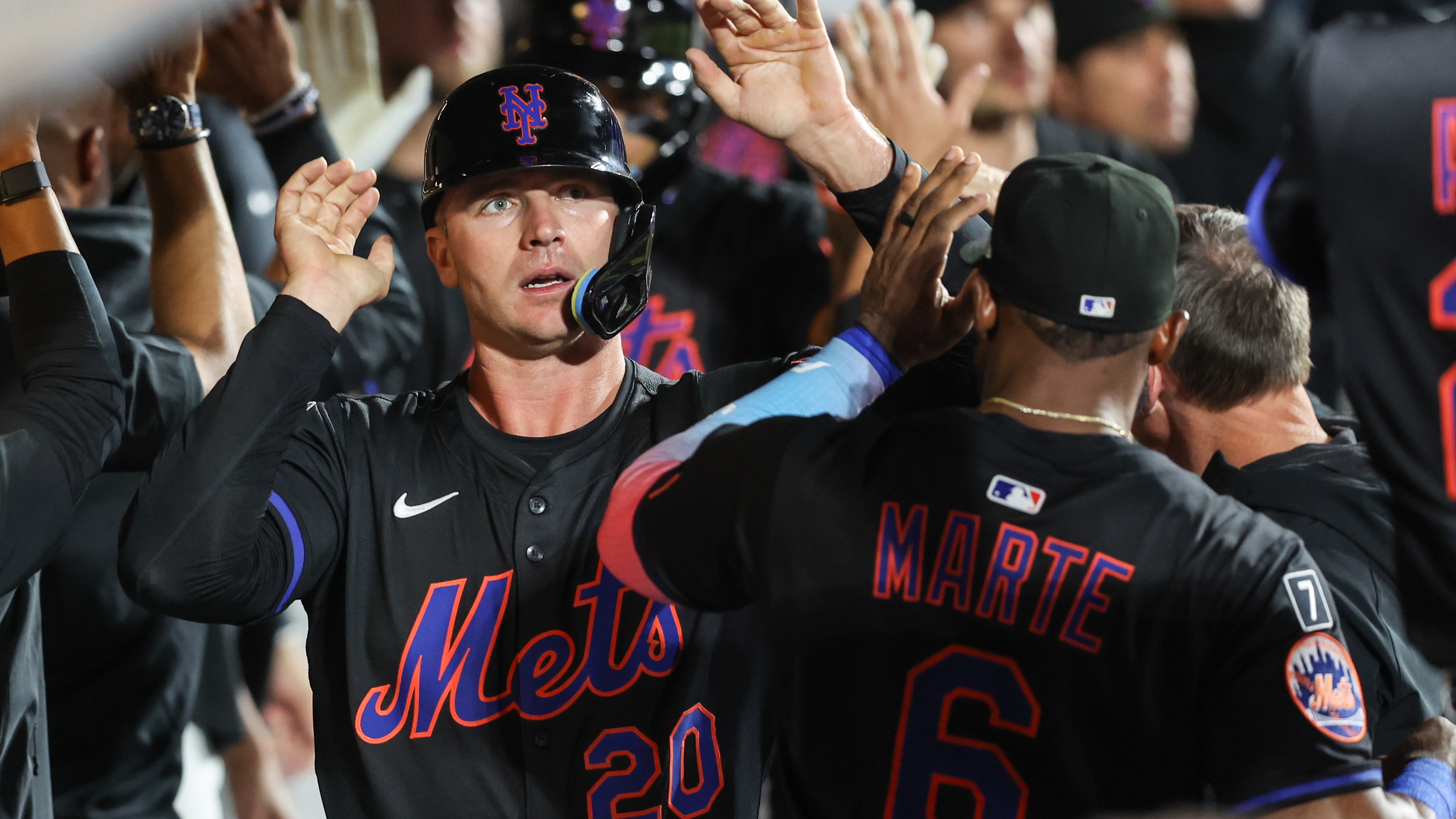 New York City, New York, USA; New York Mets first baseman Pete Alonso (20) celebrates in the dugout with his teammates after scoring in the seventh inning against the Philadelphia Phillies at Citi Field. 