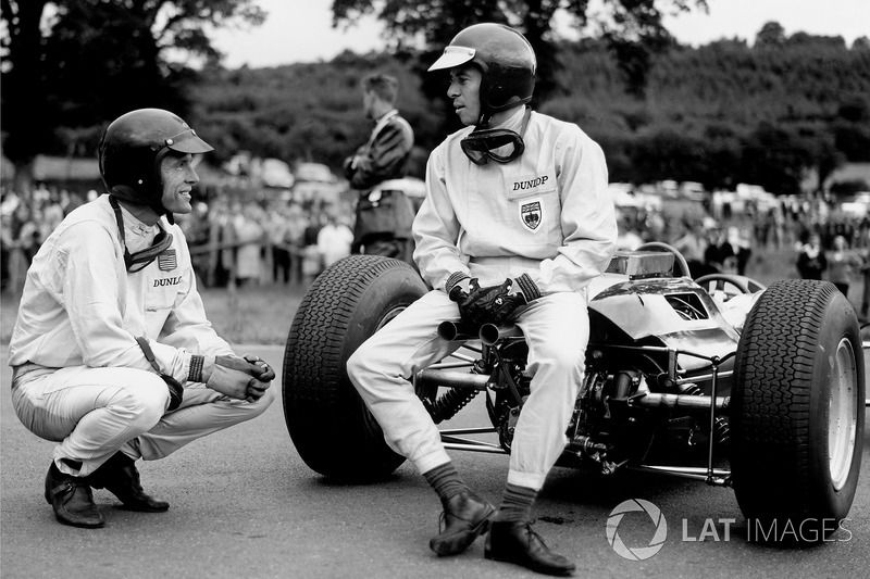 Clark employs the tailpipes of his Lotus as an impromptu seat while chatting to Gurney