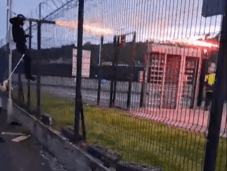Horrifying moment rival football yobs blast FIREWORKS & batter each other with sticks in huge brawl before game