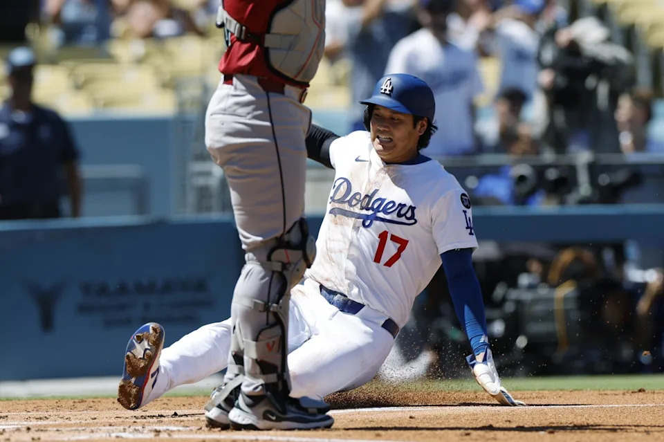 Dodgers star Shohei Ohtani scores on a double by Freddie Freeman in the first inning Sunday against Arizona.