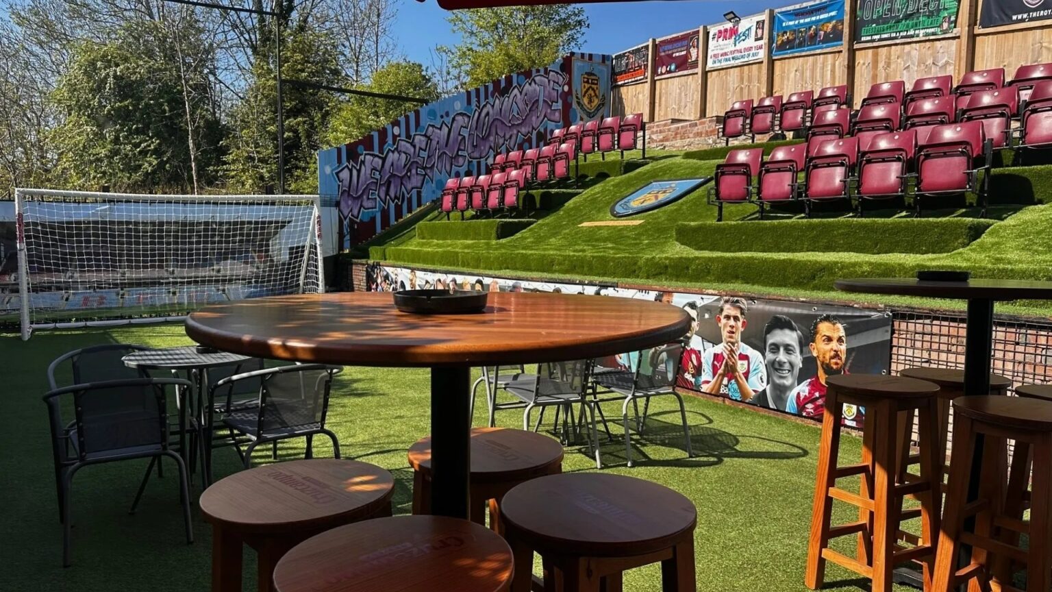 Footy-mad pub owners turn beer garden into replica Premier League stadium with terrace, dugout & pitch for new season