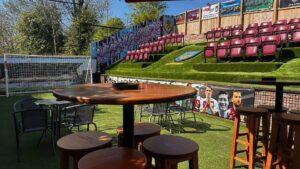 Footy-mad pub owners turn beer garden into replica Premier League stadium with terrace, dugout & pitch for new season