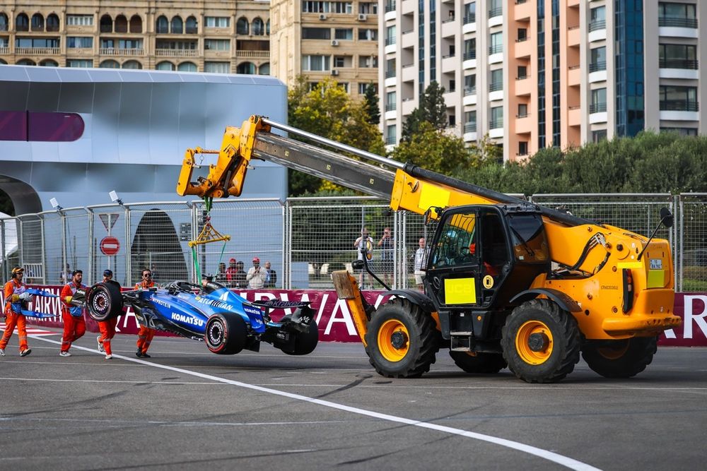 Alexander Albon's Williams is craned away from Turn 1