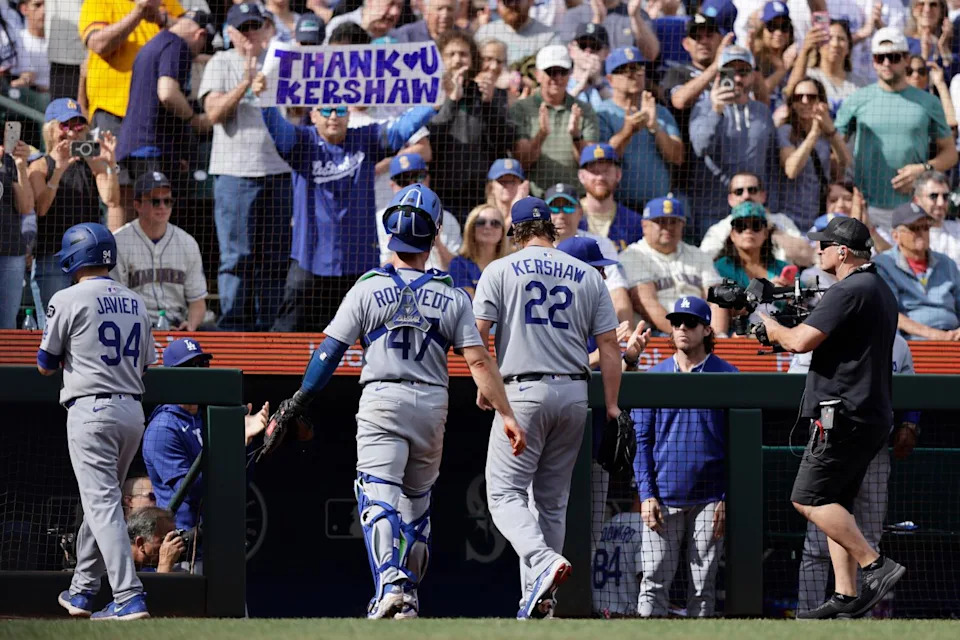 Dodgers pitcher Clayton Kershaw (22) and catcher Ben Rortvedt, center left, walk to the dugout after working the fifth inning