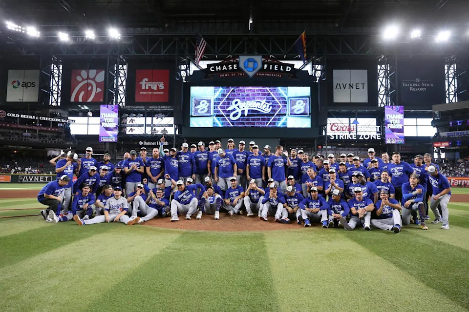Dodgers players and coaches pose for a team photo at Chase Field after beating the Diamondbacks.