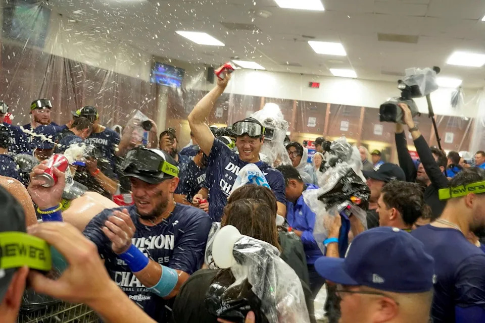 Dodgers star Shohei Ohtani, center, celebrates with his teammates after the Dodgers clinched the NL West title on Thursday.
