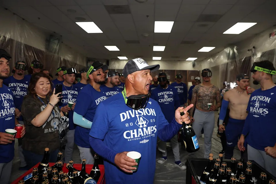 Dodgers manager Dave Roberts addresses the team in the locker room after clinching the National League West title