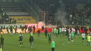 Derby clash descends into chaos as fans chase players down tunnel with riot police failing to restore order