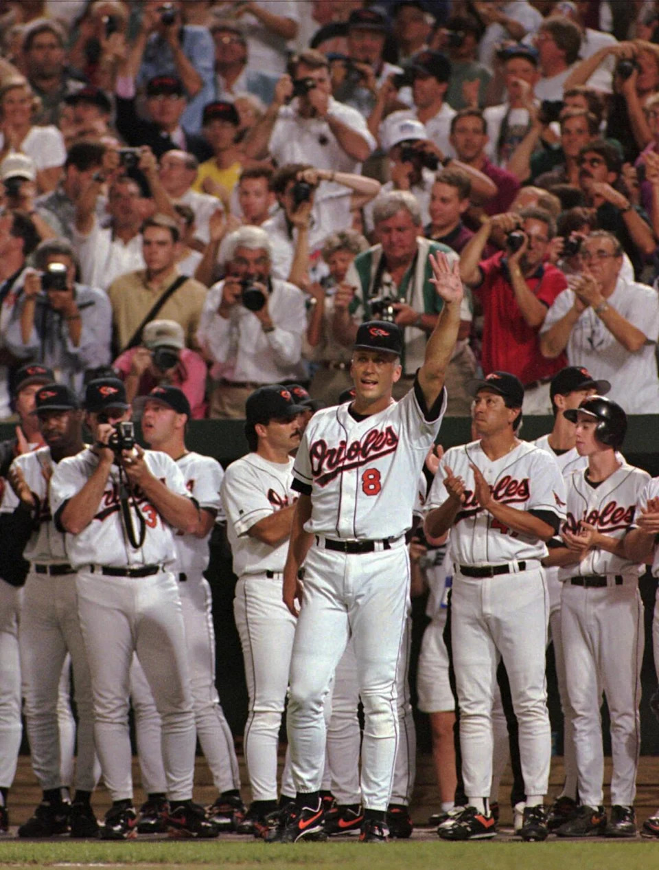 Baltimore Orioles Cal Ripken waves to the crowd in the middle of the fifth inning Sept. 6, 1995.