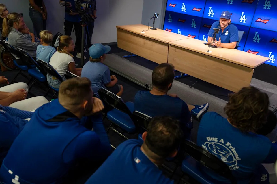 Clayton Kershaw's family and Dodgers players listen to Kershaw speak during his retirement news conference.