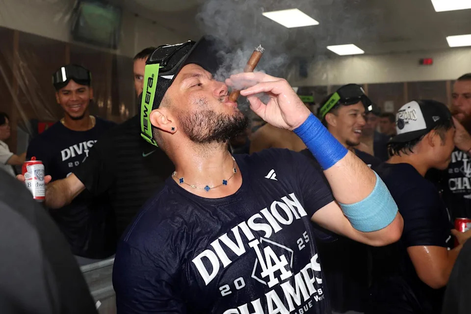 Dodgers infielder Miguel Rojas celebrates in the locker room after the team's win over Arizona to clinch the NL West title.