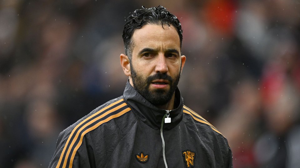 Rúben Amorim looking forward in a black and orange jacket.
