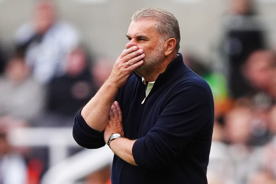 Ange Postecoglou covering his mouth with his hand.