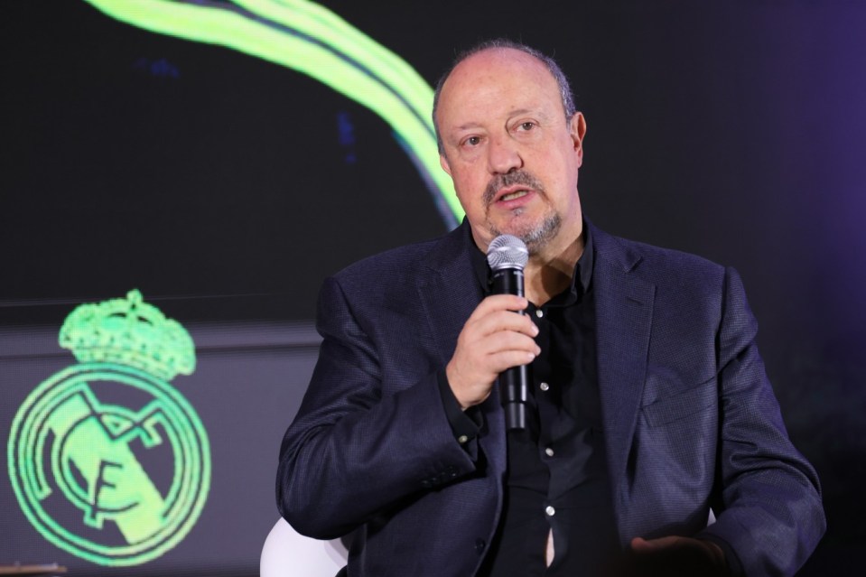 Rafael Benitez speaking into a microphone at the Festival Dello Sport in Trento, Italy.